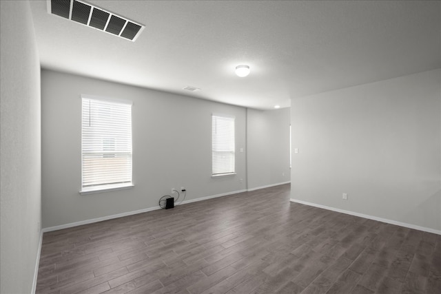 empty room with dark hardwood / wood-style floors