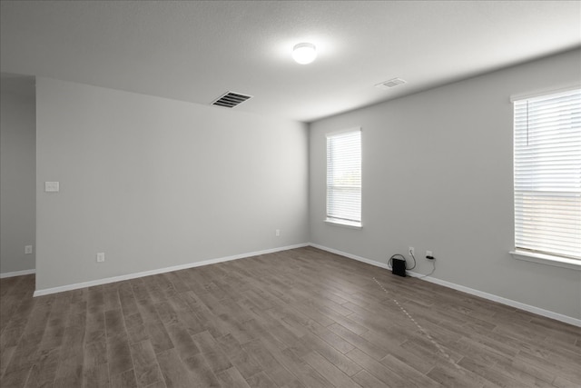 unfurnished room with dark hardwood / wood-style floors