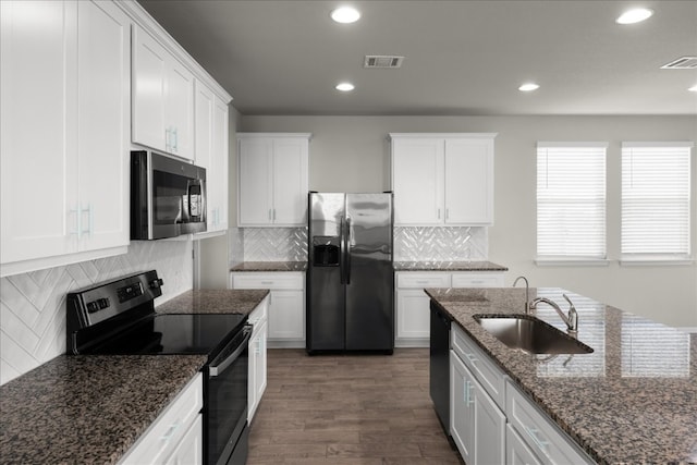 kitchen featuring black appliances, white cabinets, sink, dark hardwood / wood-style floors, and dark stone countertops