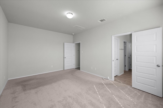 unfurnished bedroom with light colored carpet