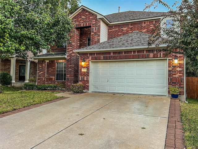 front facade featuring a front yard and a garage