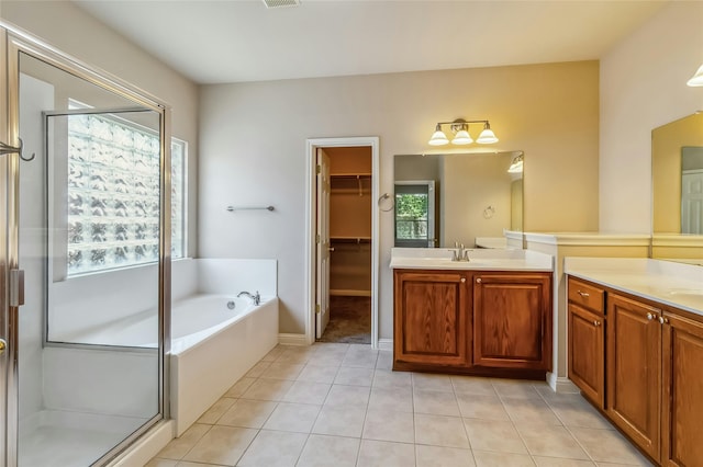 bathroom with vanity, plenty of natural light, and separate shower and tub