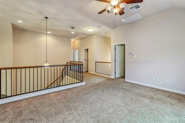 carpeted empty room with ceiling fan and lofted ceiling