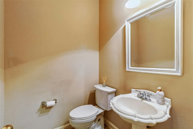 bathroom featuring sink and toilet