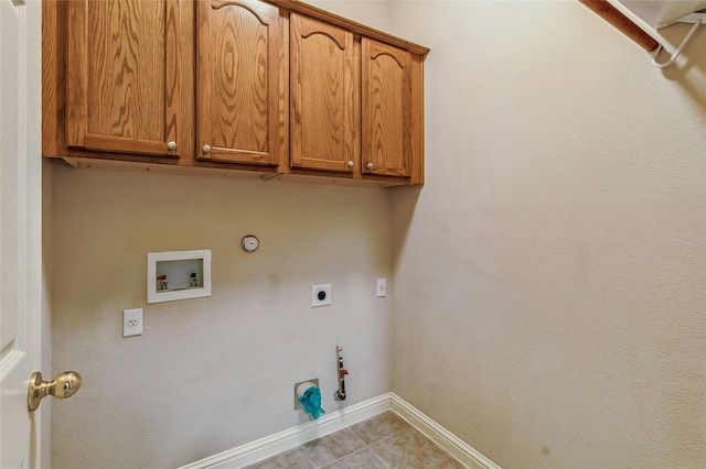 laundry room featuring electric dryer hookup, cabinets, washer hookup, and gas dryer hookup