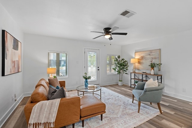 living room with wood-type flooring and ceiling fan