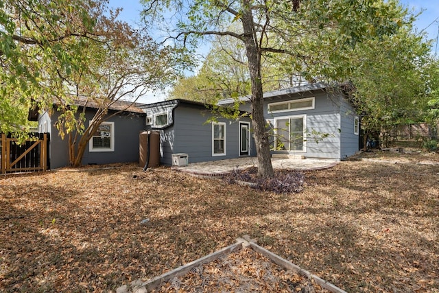 back of property with a patio