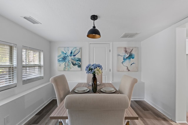 dining room with dark hardwood / wood-style flooring