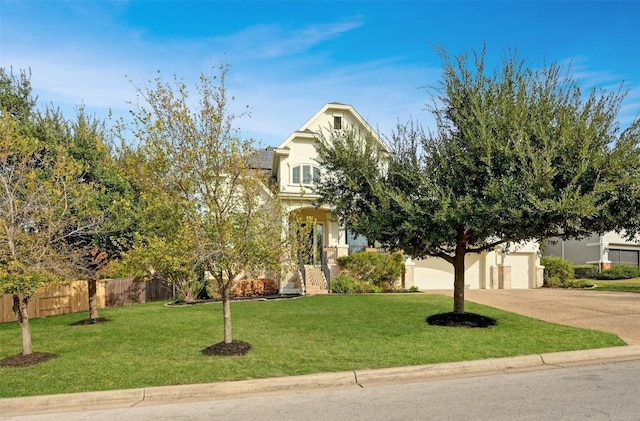 view of property hidden behind natural elements with a garage and a front lawn