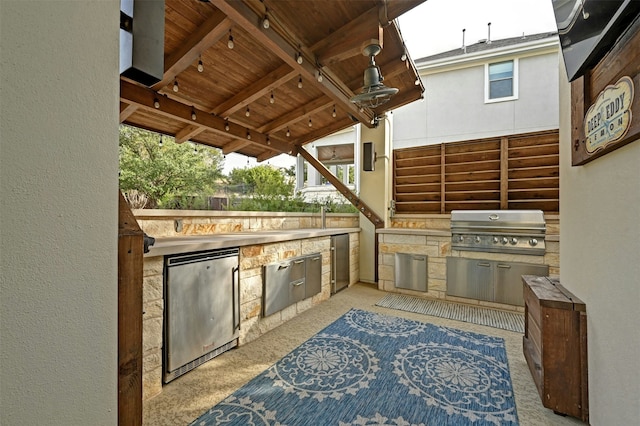 view of patio featuring a grill and an outdoor kitchen