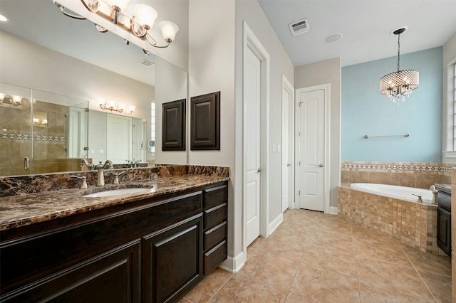 bathroom featuring an inviting chandelier, vanity, independent shower and bath, and tile patterned flooring