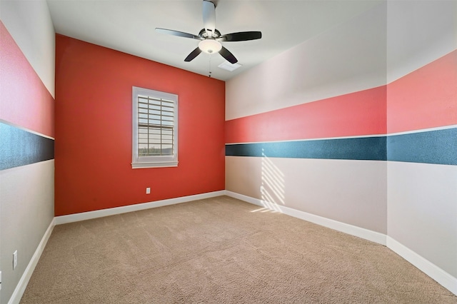 unfurnished room featuring ceiling fan and carpet