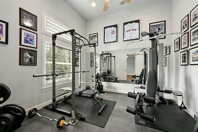 gym with a high ceiling and ceiling fan