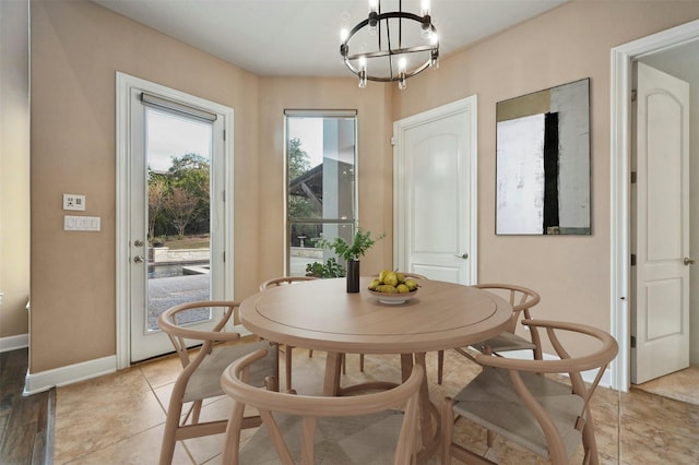 tiled dining space with a chandelier