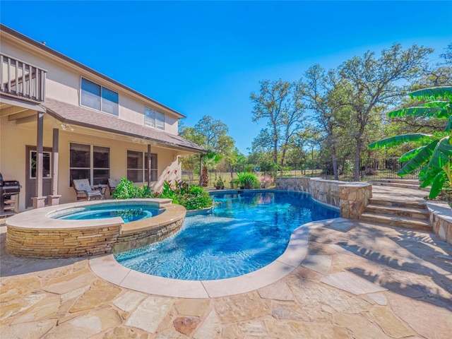 view of swimming pool with a patio area and an in ground hot tub