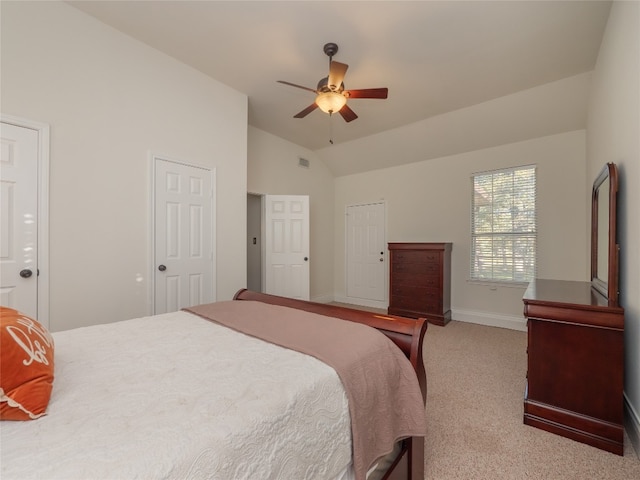 carpeted bedroom featuring ceiling fan and vaulted ceiling