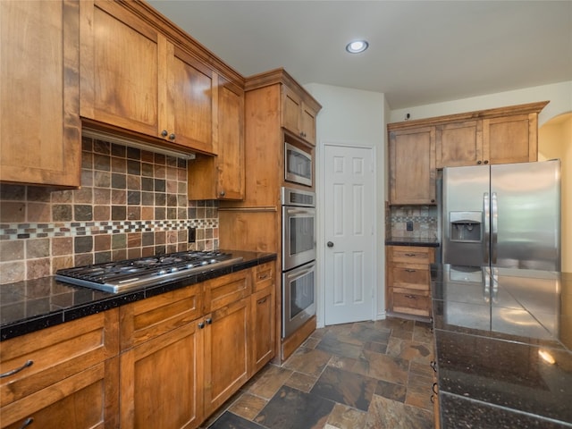 kitchen featuring appliances with stainless steel finishes and tasteful backsplash