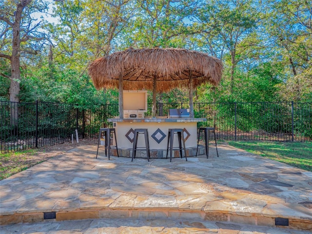 view of patio with an outdoor bar