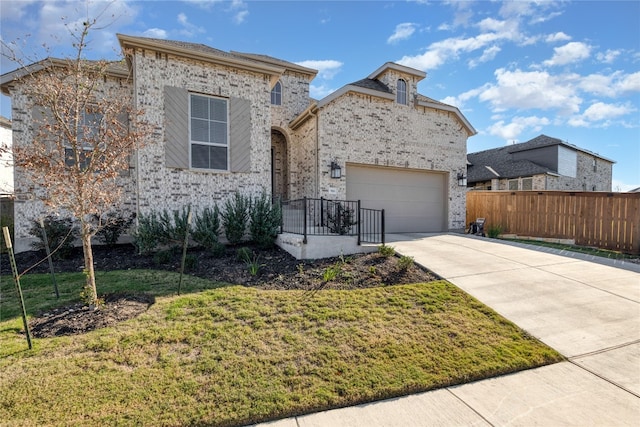 view of front of home featuring a front yard and a garage