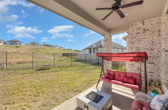 view of patio featuring a fire pit and ceiling fan