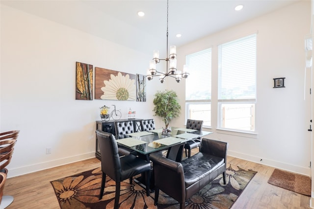 dining room featuring a notable chandelier and light wood-type flooring