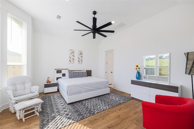 bedroom featuring multiple windows, ceiling fan, and hardwood / wood-style flooring