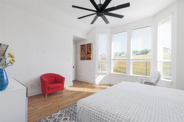 bedroom with hardwood / wood-style flooring, multiple windows, and ceiling fan