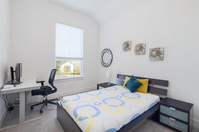 carpeted bedroom with lofted ceiling