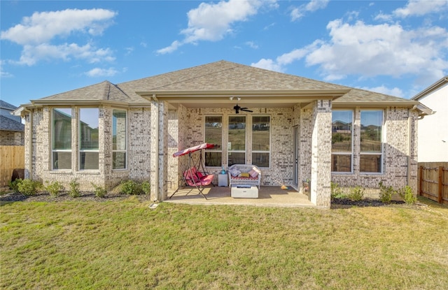 back of property featuring ceiling fan, a patio area, and a yard