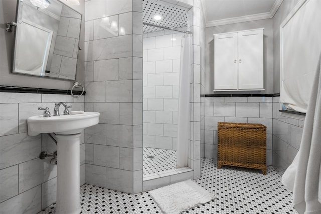 bathroom with a tile shower, tile patterned flooring, tile walls, and ornamental molding