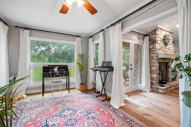 sitting room featuring crown molding, plenty of natural light, ceiling fan, and light hardwood / wood-style floors