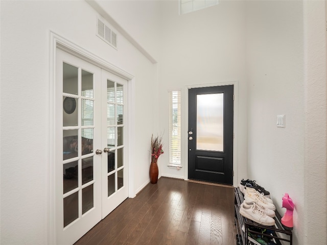 foyer with french doors and dark wood-type flooring