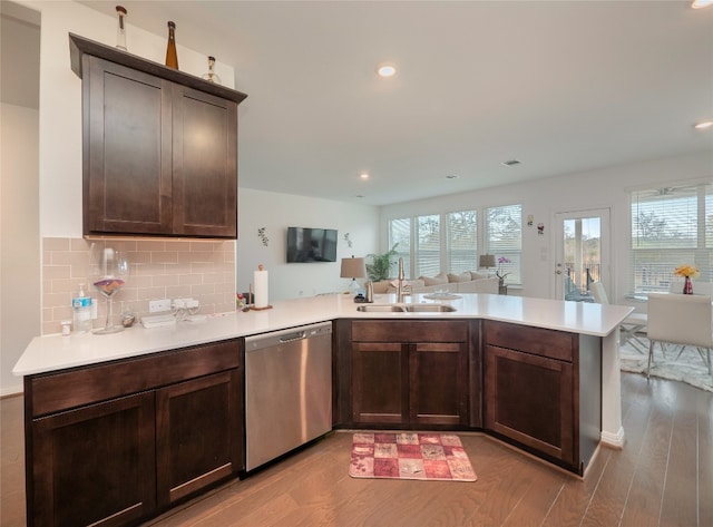 kitchen featuring dishwasher, kitchen peninsula, sink, light hardwood / wood-style flooring, and dark brown cabinetry