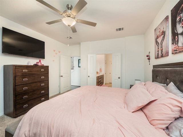 bedroom featuring ensuite bath, ceiling fan, and carpet floors