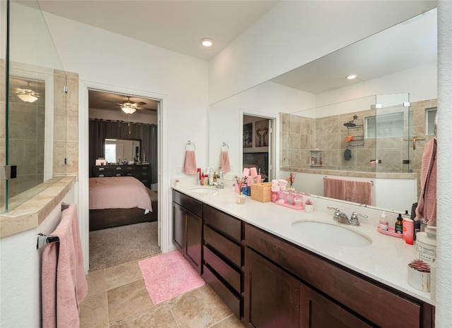 bathroom with vanity and a tile shower