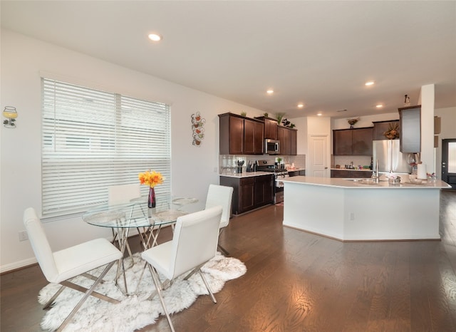 dining room featuring dark hardwood / wood-style flooring and sink