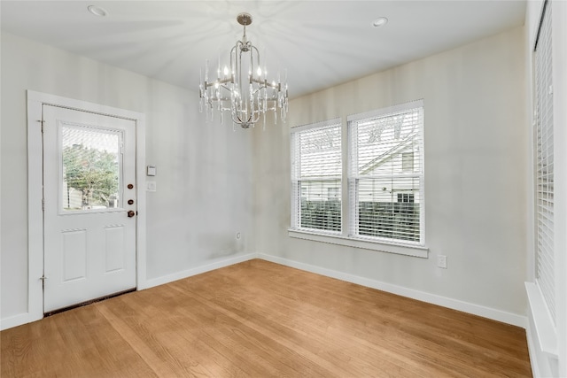 entrance foyer featuring hardwood / wood-style flooring and a chandelier