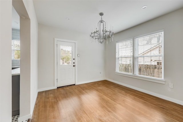 foyer featuring hardwood / wood-style flooring and an inviting chandelier