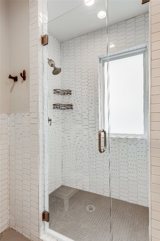 bathroom with a shower with shower door