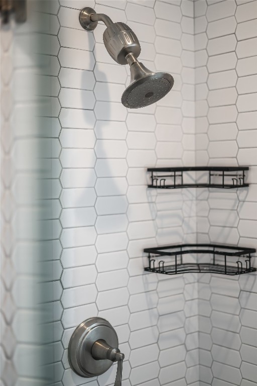 interior details featuring a tile shower