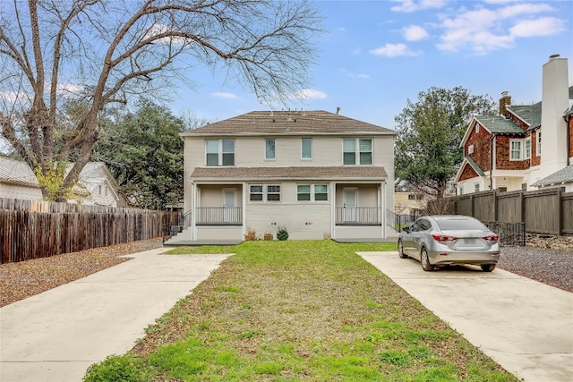 rear view of property featuring a yard