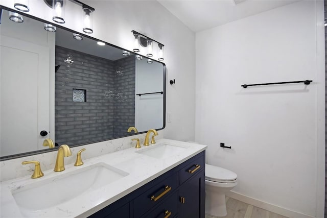 bathroom featuring hardwood / wood-style flooring, a shower, vanity, and toilet