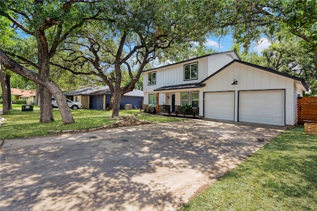 view of front of house with a front yard and a garage