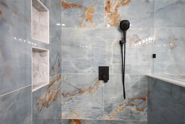 bathroom with tiled shower