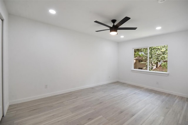 unfurnished room with ceiling fan and light wood-type flooring