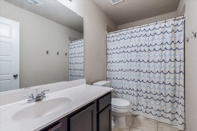 bathroom featuring vanity, tile patterned flooring, a shower with shower curtain, toilet, and a textured ceiling