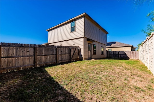 back of property featuring a yard