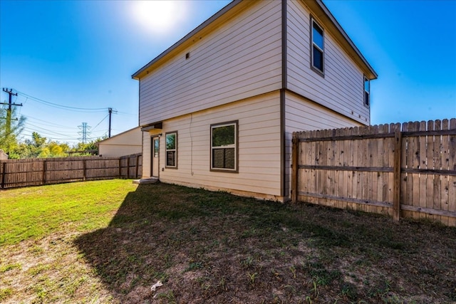 back of property featuring a yard