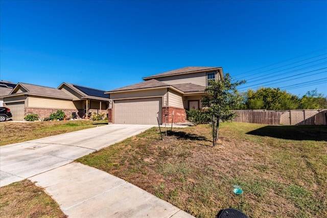 view of front of property featuring a garage and a front lawn