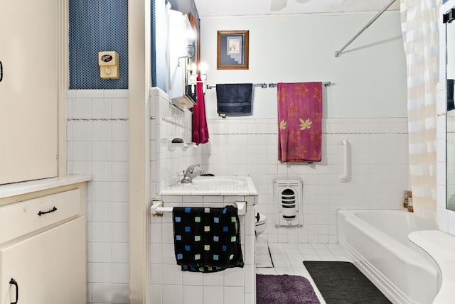 bathroom with tile patterned floors, vanity, shower / bath combination, and tile walls